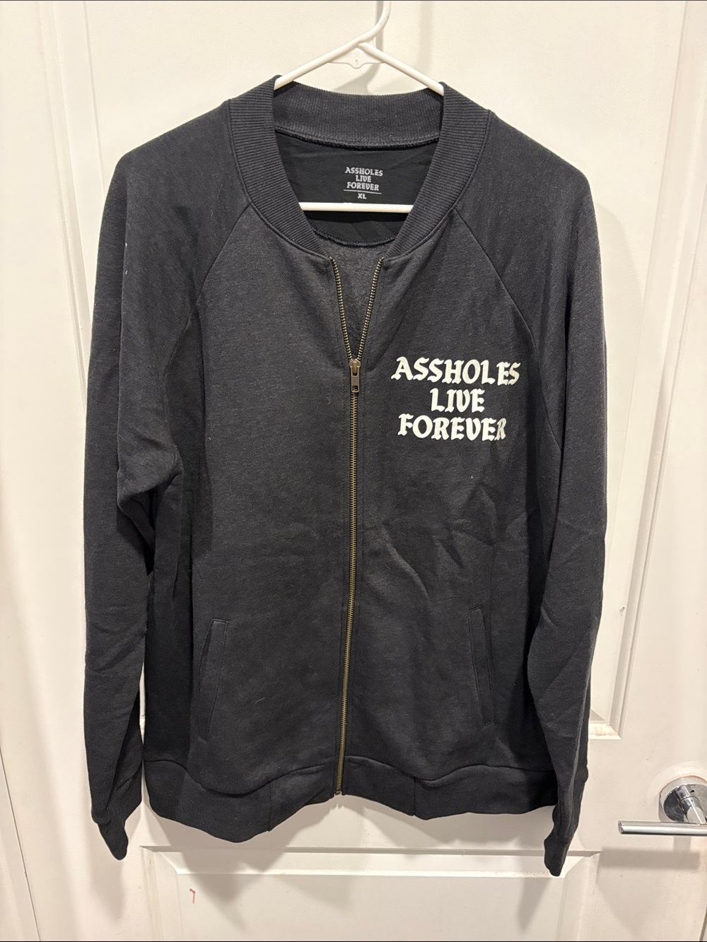 Linda Finegold Charcoal Zip-Up Sweatshirt "Assholes Live Forever"
